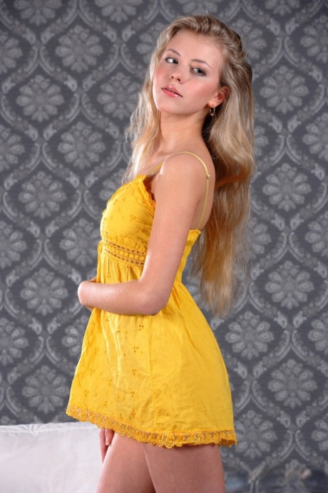 Coy model Barbara D doffs her yellow dress to reveal a smooth shaved pussy 74610413