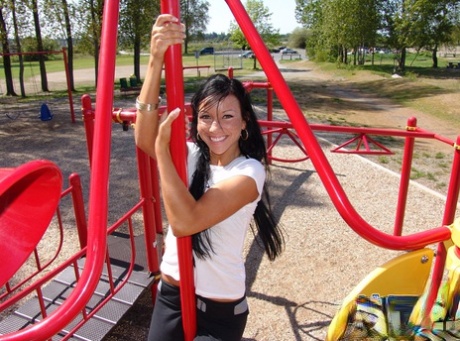 Dark-haired girl Trista Stevens frolics around a playground in a bikini 68275993