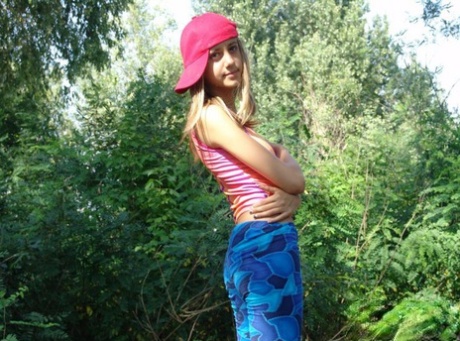 Blonde teen goes to lift up her tank top with her ball cap on sideways 11025422