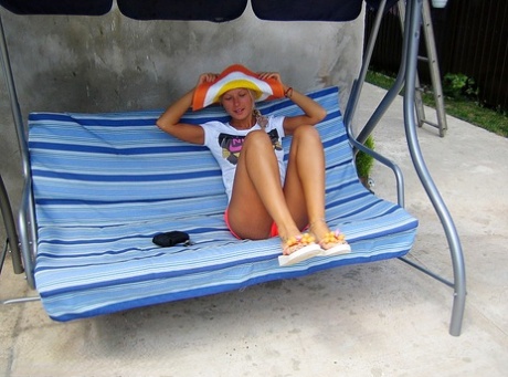Caucasian girl Adele crosses her bare legs while wearing a sun hat and shorts 71858810