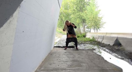 Blonde girl Jenna Lovely pulls down her pants to pee on a patch of concrete 44243898