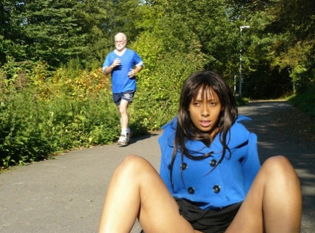 Ebony chick fingers her pussy on roadway while a jogger passes by 72740330