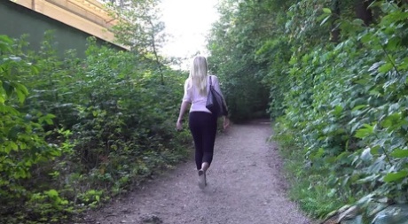 Blonde girl Delphine takes a pee on a dirt path near some greenery 51979350
