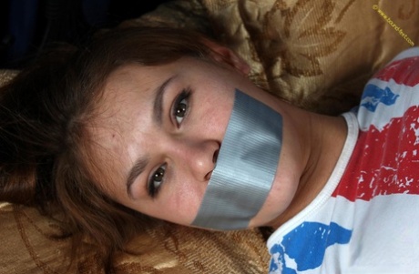 White girl is silenced with duct tape while hogtied in a T-shirt and panties 59503220