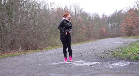 Pale redhead Redfox takes a piss on a rural road during a dull day 20654972