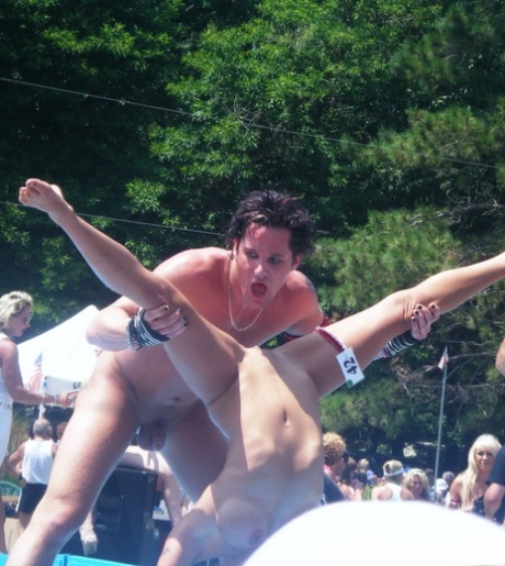 Female strippers get naked on an outdoor stage at a clothing optional club 67377696