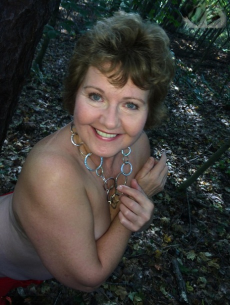 Older amateur Busty Bliss displays her great tits and bald cunt in the woods 64095860
