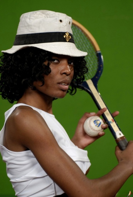 Ebony teen Nubia holds a tennis racket and ball while getting naked in a hat 99809149