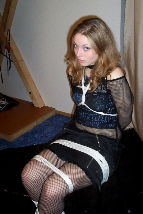 Solo model is tied up with rope while fully clothed in white boots 94702931