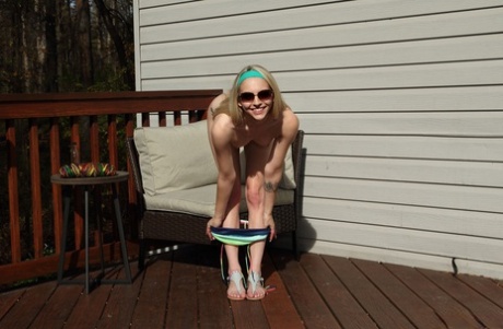 Blonde teen Lily Larimar eats a banana during vaginal insertions on a deck 12637886