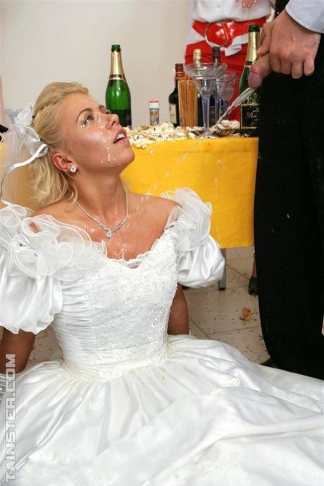 New bride dressed in her wedding dress plays water sport games at reception 82550444