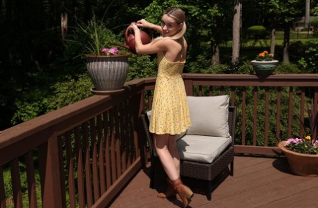 Young blonde Khloe Kingsley attaches clamps to her labia lips on a deck 32460178