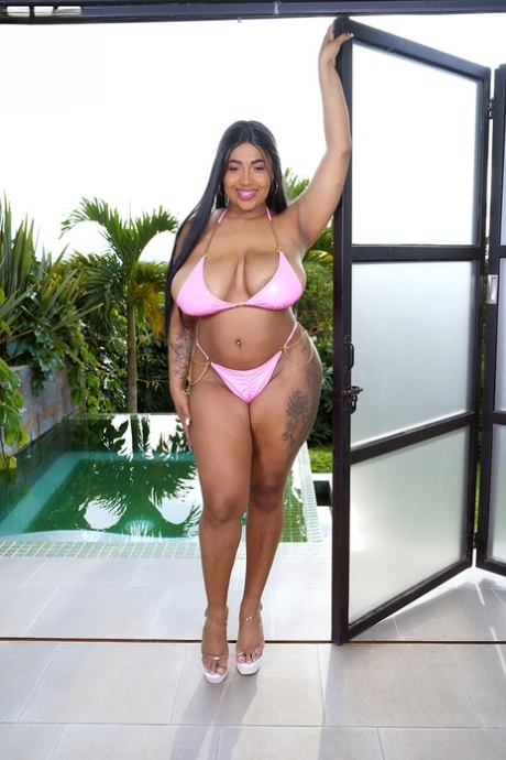 Solo girl Thayana releases her huge oiled tits from a bikini 34209302