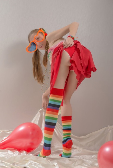Skinny teen girl in pigtails and multi-colored socks takes off her clothes 19960219
