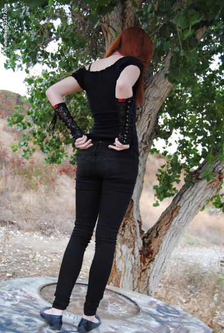 Redhead punk chick Nicci Vice showing off natural tits in forest 88109285